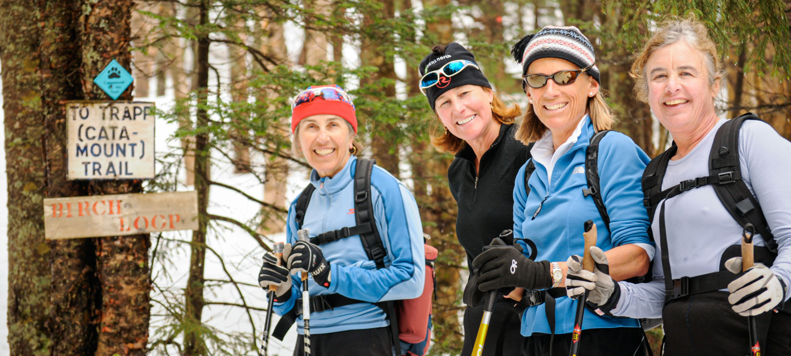 4 women skiiing smiling for the camera